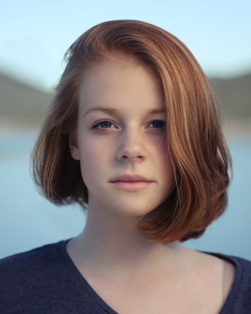 Portrait of Nora by the kitchen window in early light